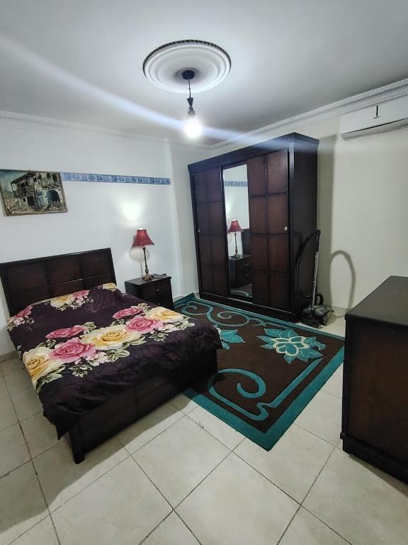a bedroom with a bed and a cabinet and a rug at شقة14 in Irbid