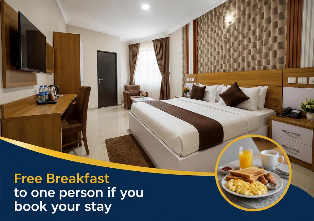 a hotel room with a bed and a plate of food at Aneks Ibro Hotel, Wuse Zone 5, Abuja in Abuja