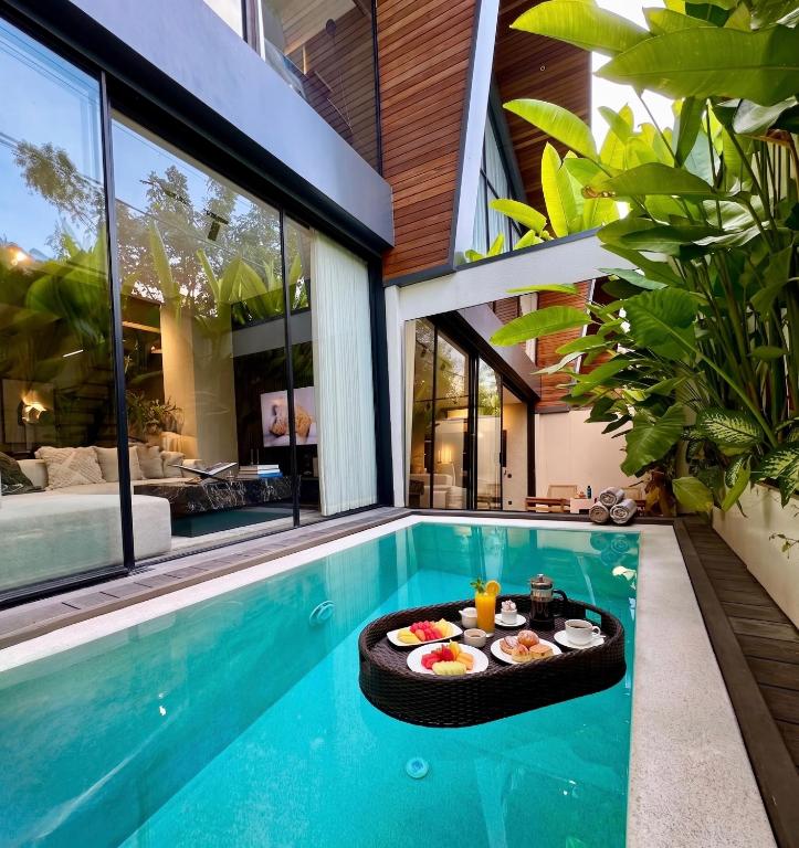 a swimming pool with a table with food in a house at Superior Luxury Loft with Working Desk, Instagramable Pool in Kerobokan