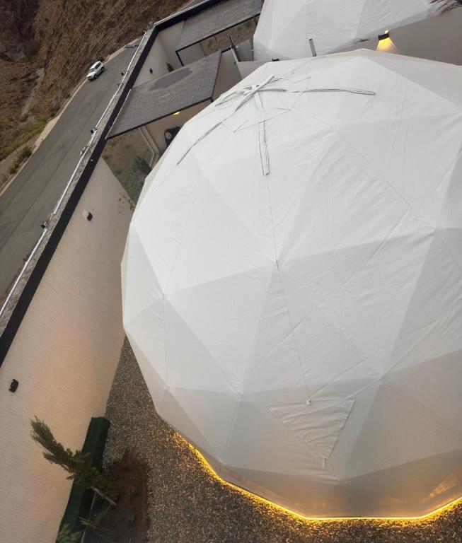 a white umbrella sitting on top of a building at سكون in Al Baha