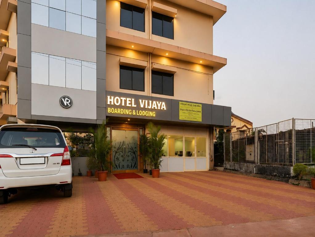 a car parked in front of a hotel villa at Hotel Vijaya Suites in Manipal