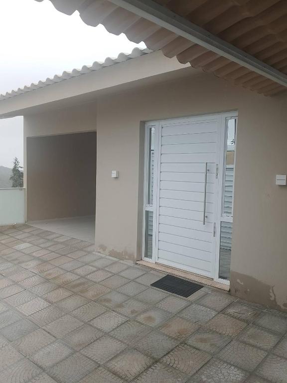 a white garage with a door on a house at Residência completa e com garagem in Garanhuns