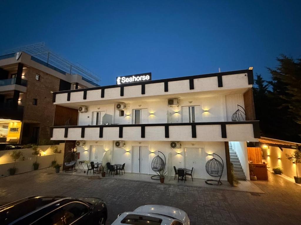 a building with a parking lot in front of it at Seahorse in Ksamil