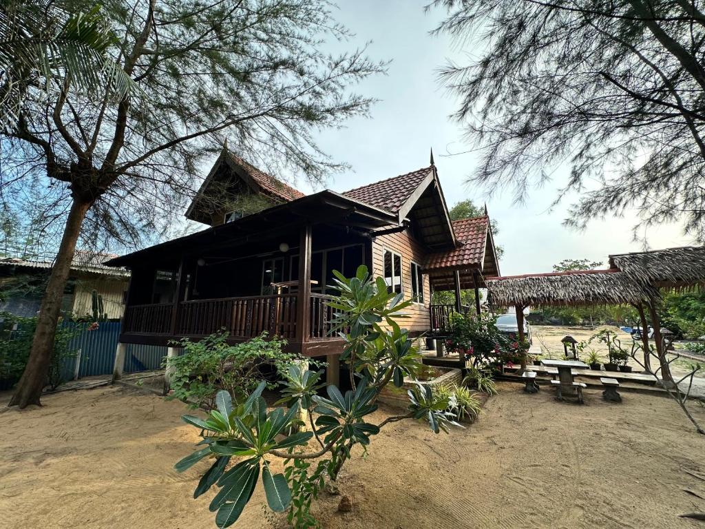 a small house with a porch and a deck at Rumah D'Rhu, Zaki's Residence in Marang