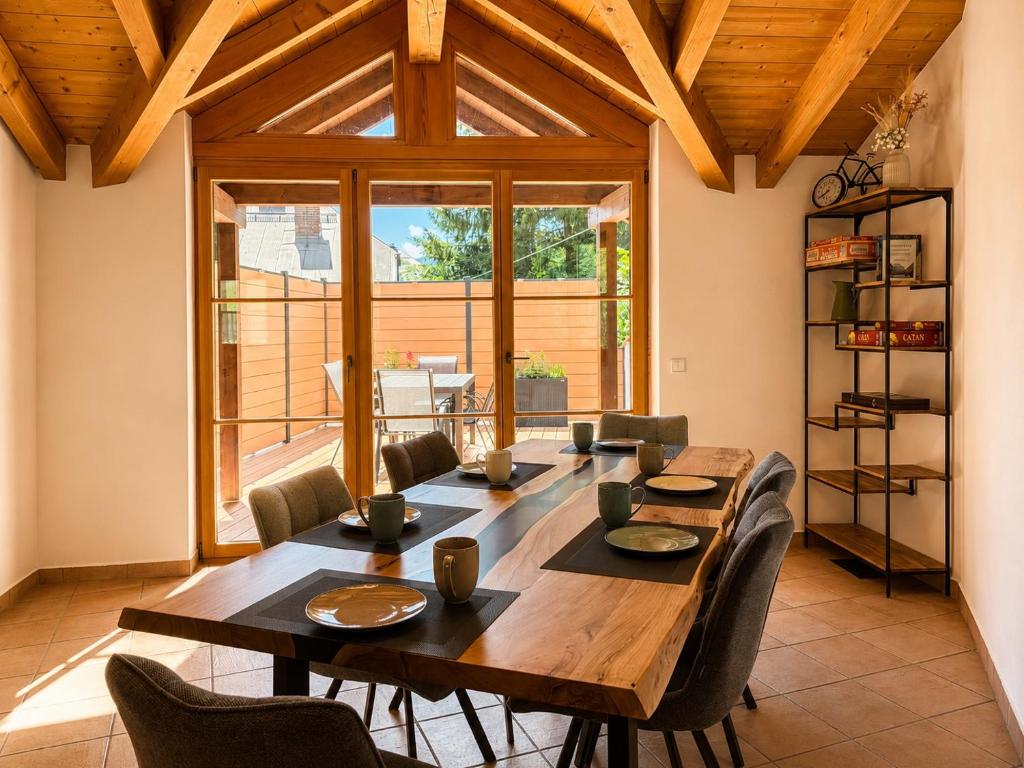 a dining room with a large wooden table and chairs at NaturZeit Melleck in Schneizlreuth