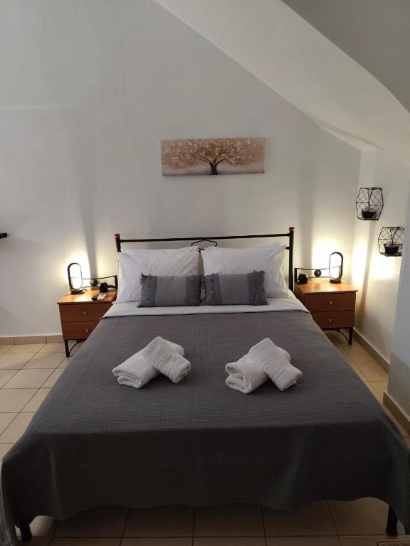a bedroom with a bed with two towels on it at Afrodite's Room 1 in Kámbos