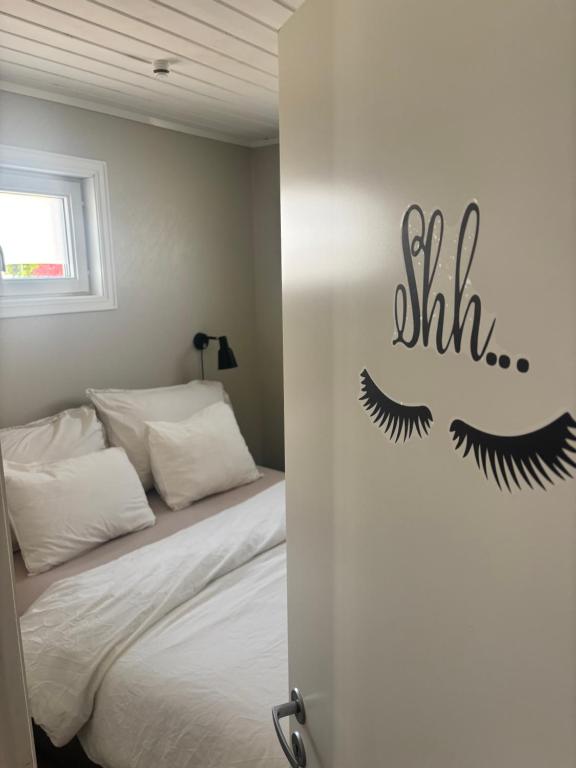 a bedroom with a bed with lashes on the wall at Casa Brekka in Bamble