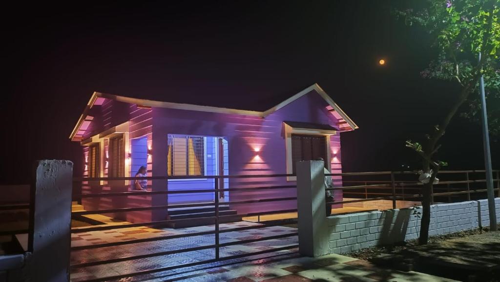 a small house lit up at night at Vihanka villa in Tāhārpur