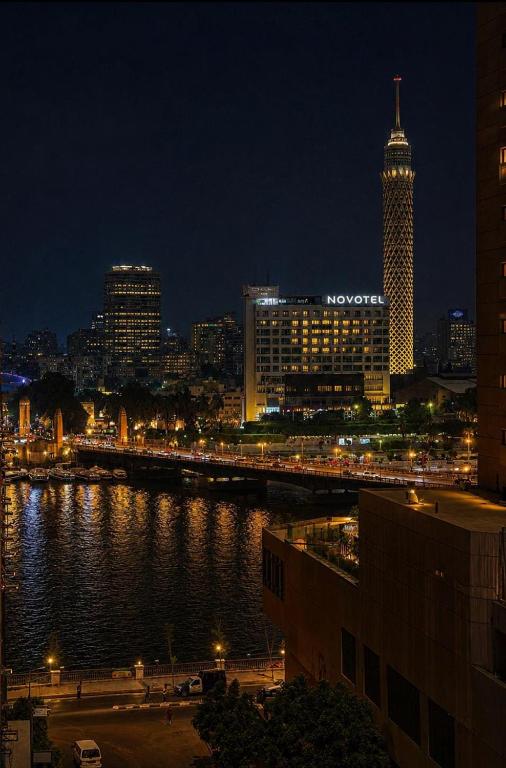 a view of a city at night with a river at Town Hotel Cairo in Cairo