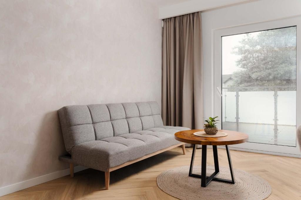 a living room with a couch and a table at Ciche Tarasy in Stężyca