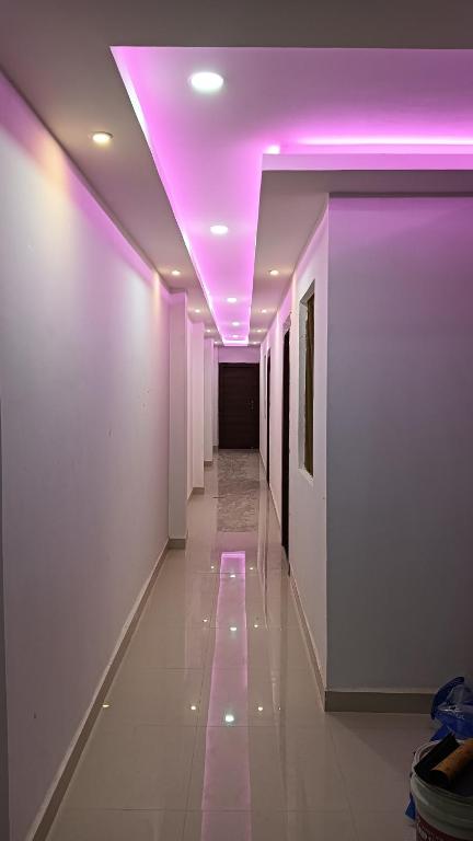 a hallway with purple lights in a building at Hotel Janki Inn in Deoghar