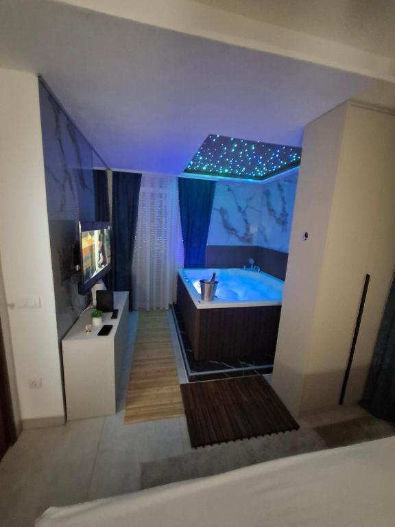 a bathroom with a blue tub in a room at Centar Spa Teslic in Teslić