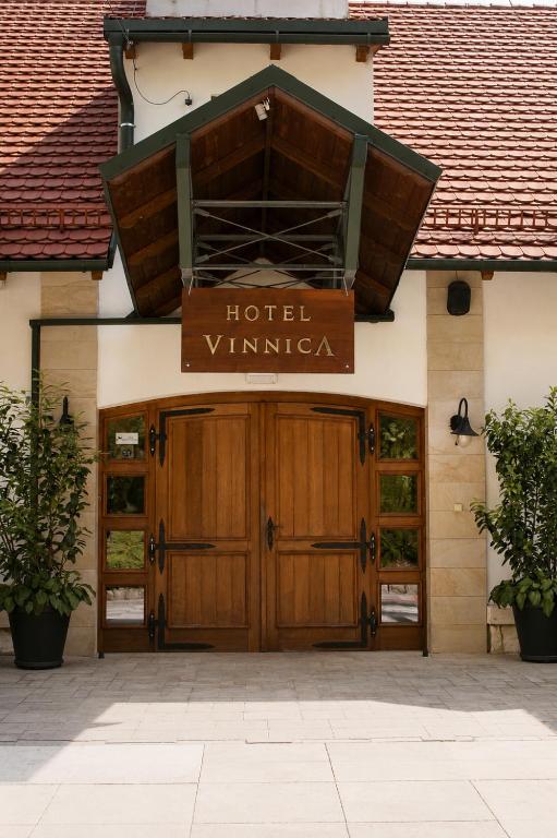 a hotel entrance with ajar doors and a sign that reads hotel winner at Hotel Vinnica in Wieliczka
