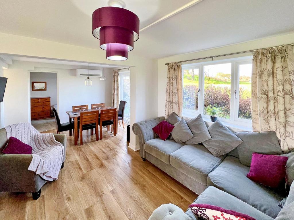 a living room with a couch and a table at Primrose Apartment - Uk49291 in Woolfardisworthy