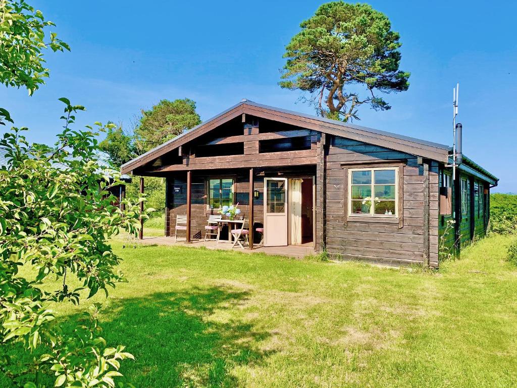 a small wooden house on a grass field at Skylark Lodge - Uk51678 in Carsethorn