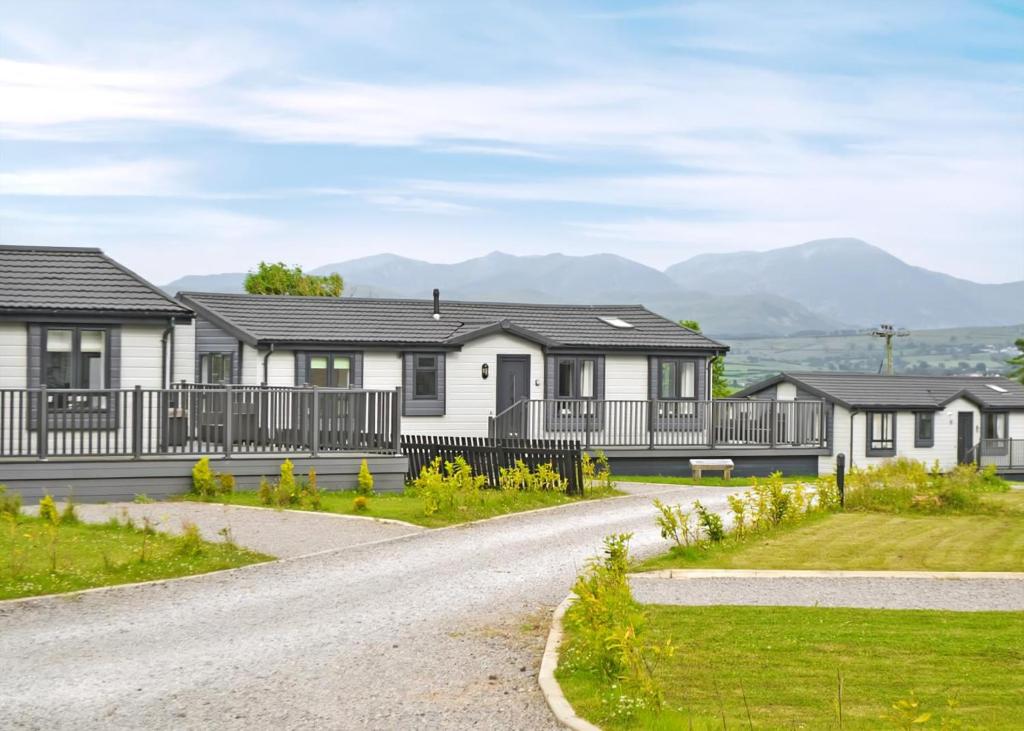 a row of houses with mountains in the background at Lillyhall Lodge Retreat in Workington