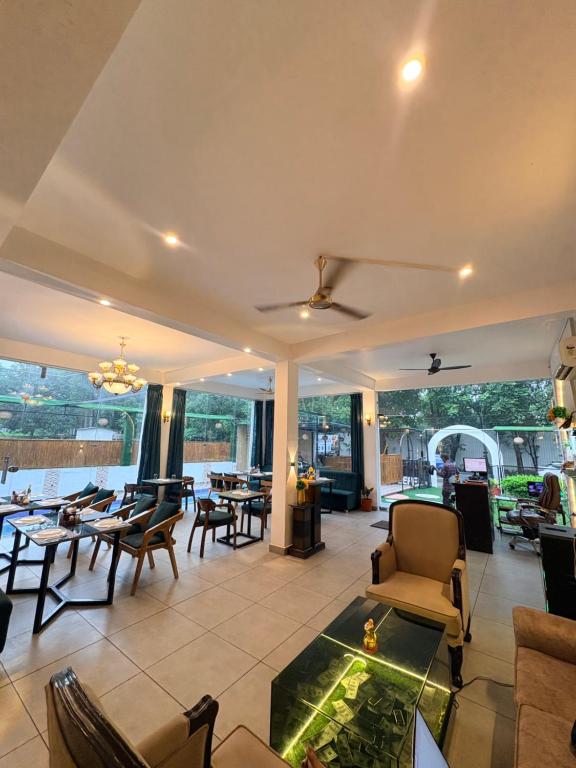 a living room with a couch and chairs and a table at Lagoon Bites in Jhājra