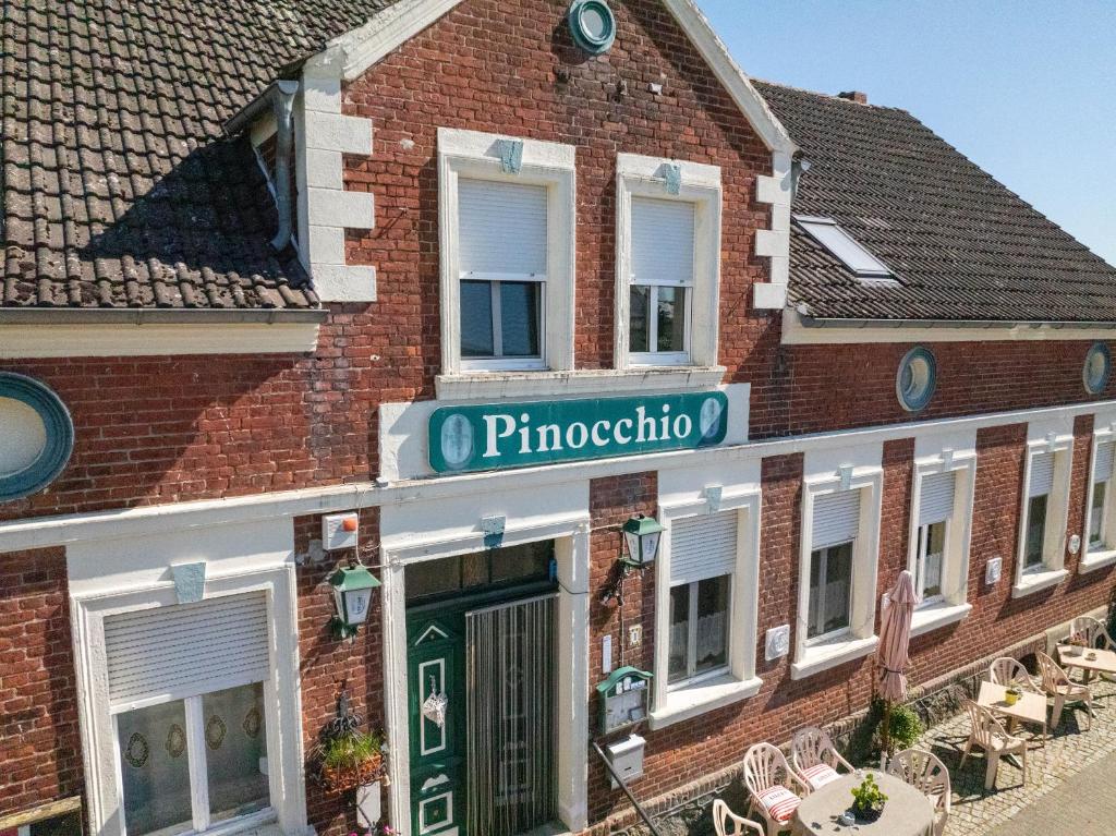 a brick building with a sign for a pharmacy at pinocchio pirow in Pirow