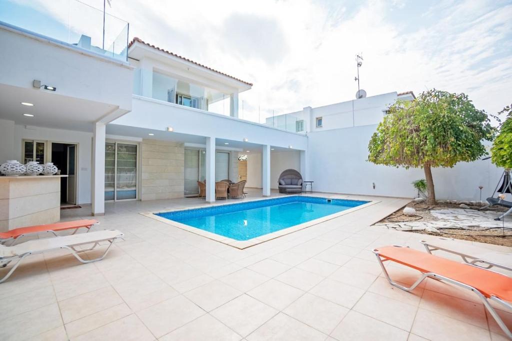 a swimming pool in the backyard of a house at Beachfront Villa Larnaka Dhekelia with Pool in Pyla