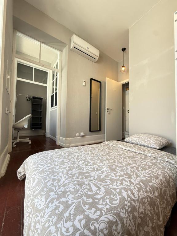 a bedroom with a large bed and a window at Faro Coast Guest House in Faro