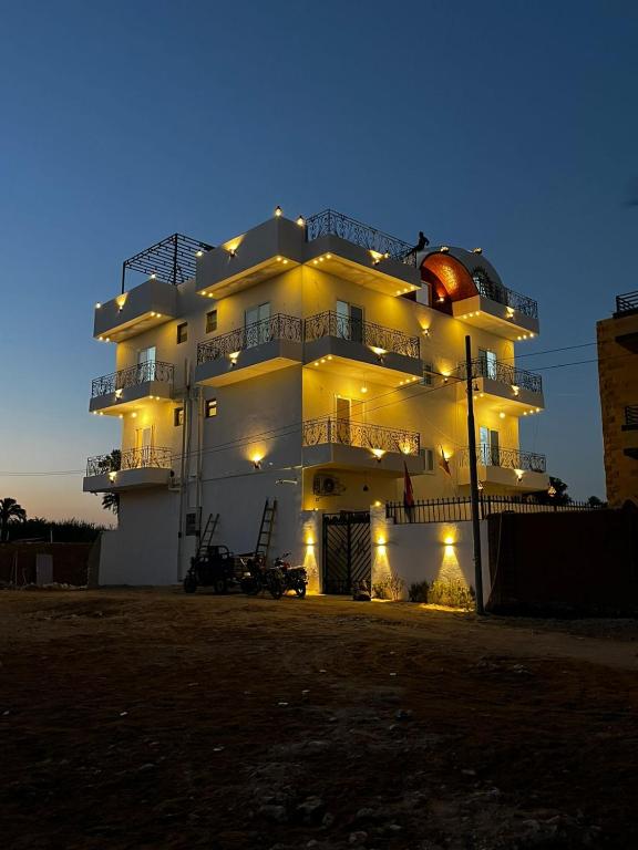 a large building with lights in front of it at Villa Mena Luxor in Luxor