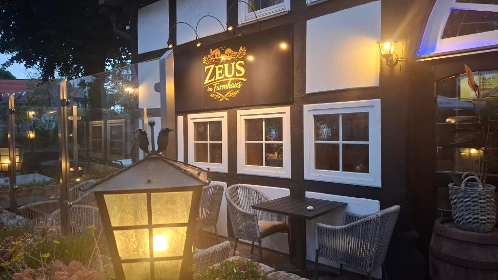 a restaurant with a lit sign on the side of a building at Gasthof Altes Farmhaus in Lienen