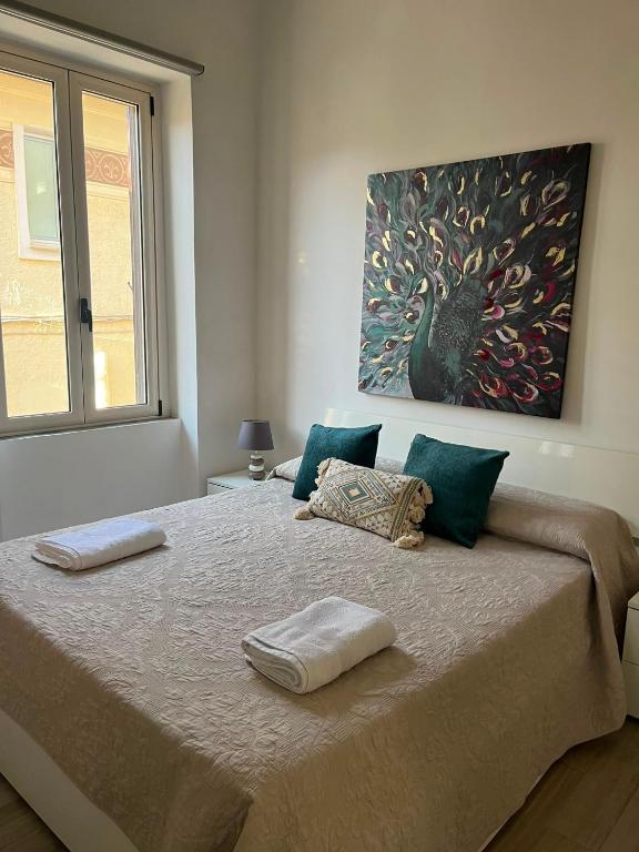 a bedroom with a large bed with two towels on it at LaDependance Hotel Scilla in Scilla