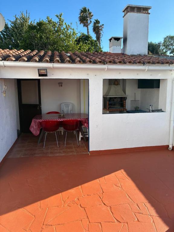 a white house with a table and chairs on a patio at Casa 13 in Montargil