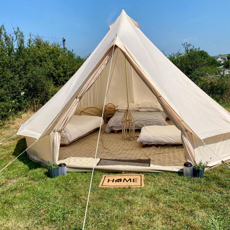 a canvas tent with a sign that says trance at Boscastle Bell Tents in Boscastle