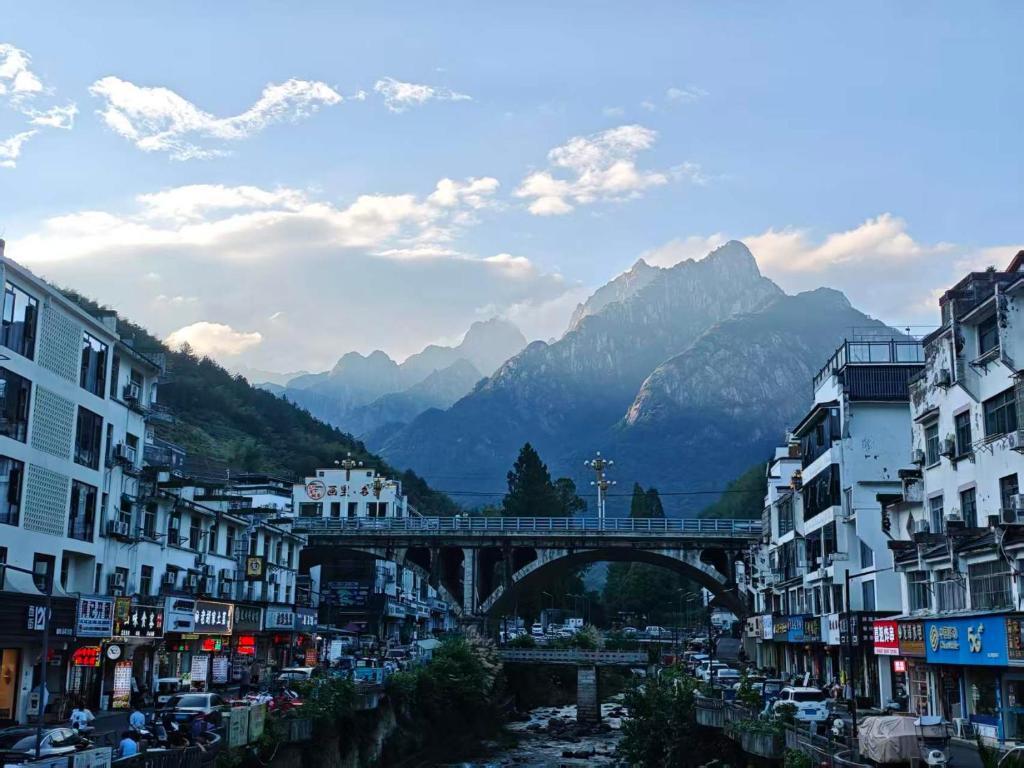 a bridge over a river in a city with buildings at 0517 Boutique Hotel in Huangshan City
