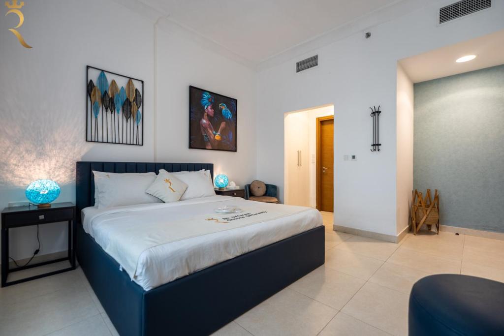 a bedroom with a large bed in a room at Yas Island 1BR - Coastal Blue Haven in Abu Dhabi