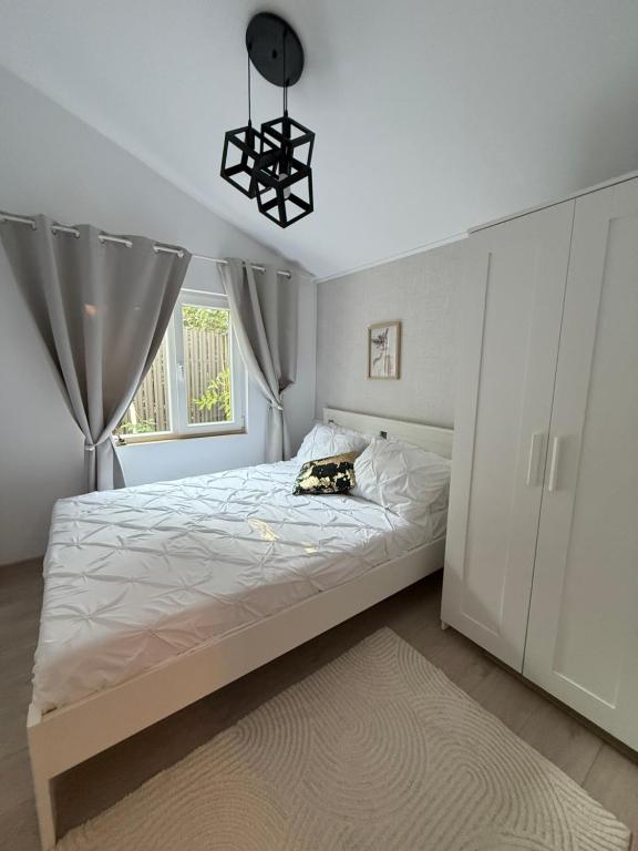 a bedroom with a large bed and a window at Vila Luna in Năvodari
