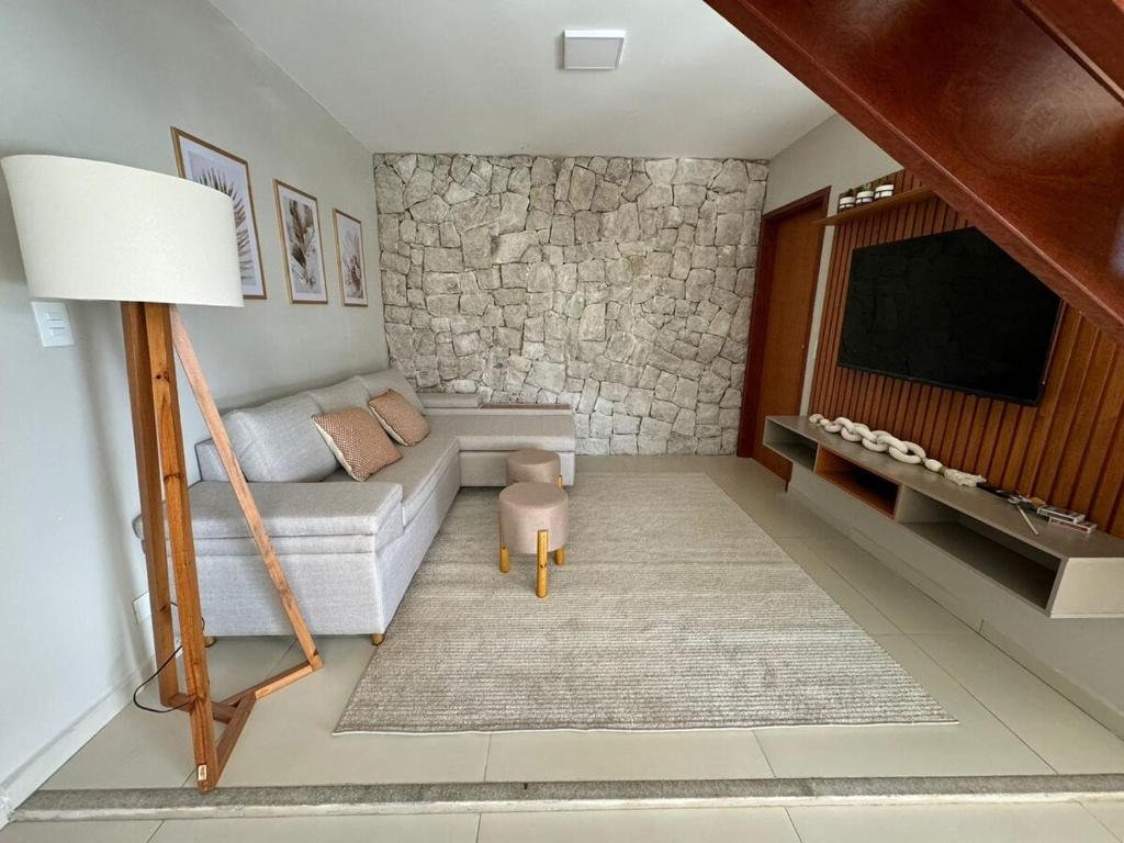 a living room with a couch and a tv at Charming house in countryside in Brotas