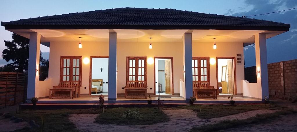 a home with a porch with chairs and lights at Hungry Wave in Arugam Bay