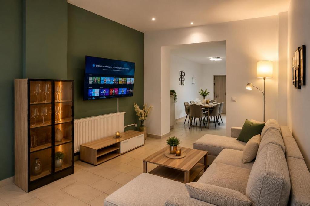 a living room with a couch and a tv at Arcade Apartment Bad Oldesloe in Bad Oldesloe
