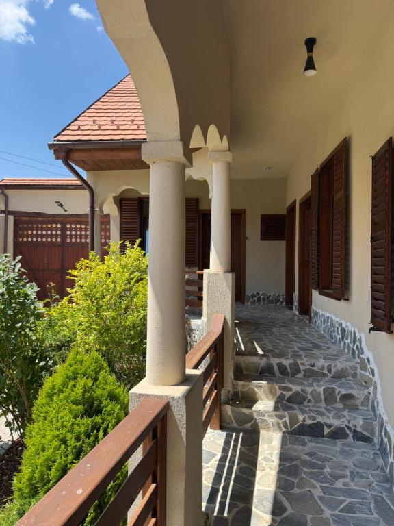 a porch of a house with pillars and a fence at Ohaba 140-141 By Holztreppe in Ohaba