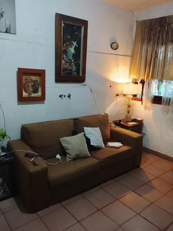 a brown couch sitting in a living room at Fabylu in Ezpeleta