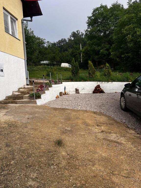 a car parked in front of a house at REBL Suites in Sutješčica