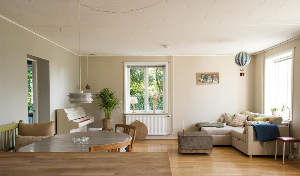 a living room with a table and a couch at Spjutstorp's old school and rectory 2 in Tomelilla