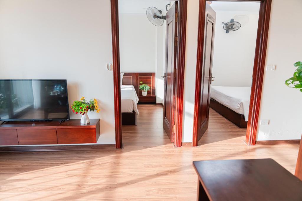 a living room with a television and a large mirror at A89 Hotel & Spa Hanoi in Hanoi