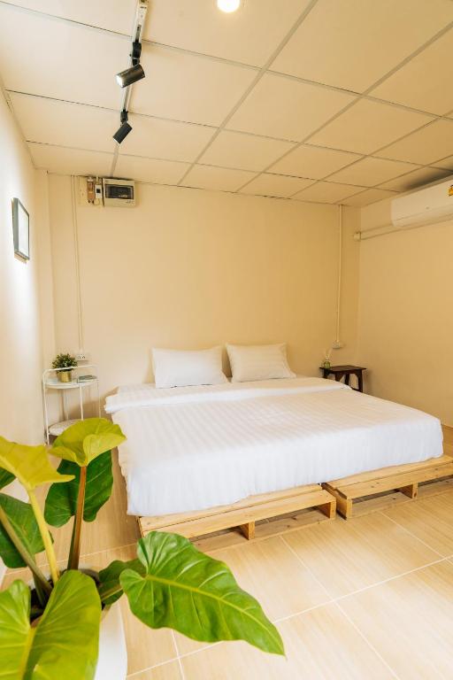a bed in a room with green plants at Always Boutique Stay in Pai