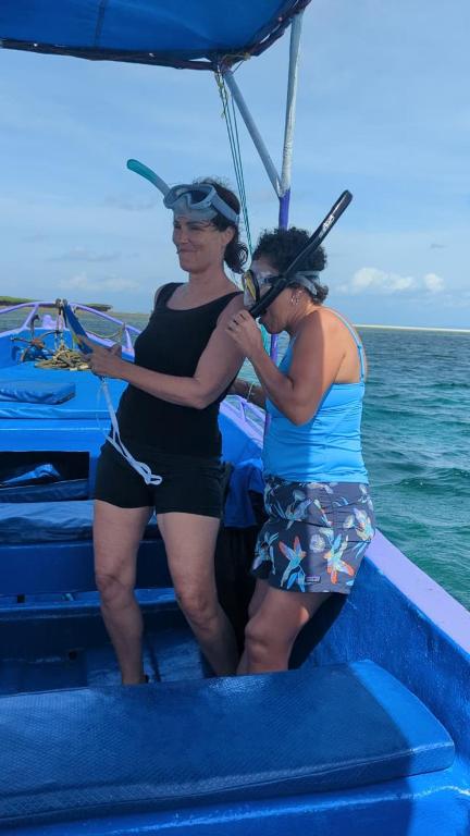 two women standing on a boat in the ocean at PASIFIC OCEAN TOUR's in Wasini Island