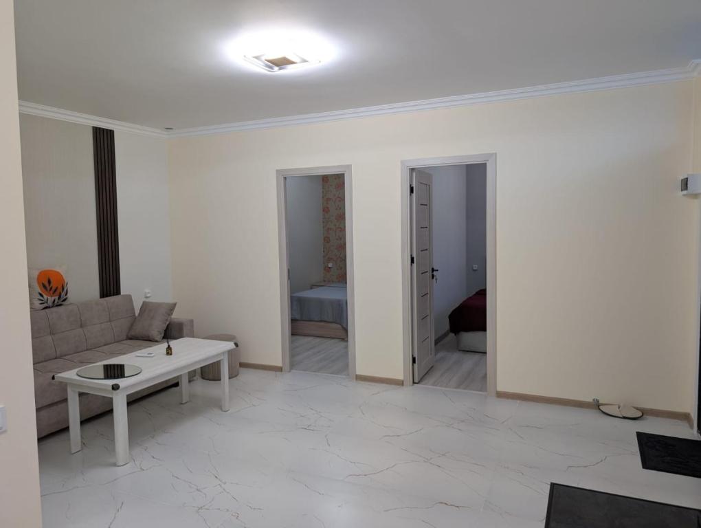 a living room with a couch and a table at Erevanyan House in Pʼarakʼar