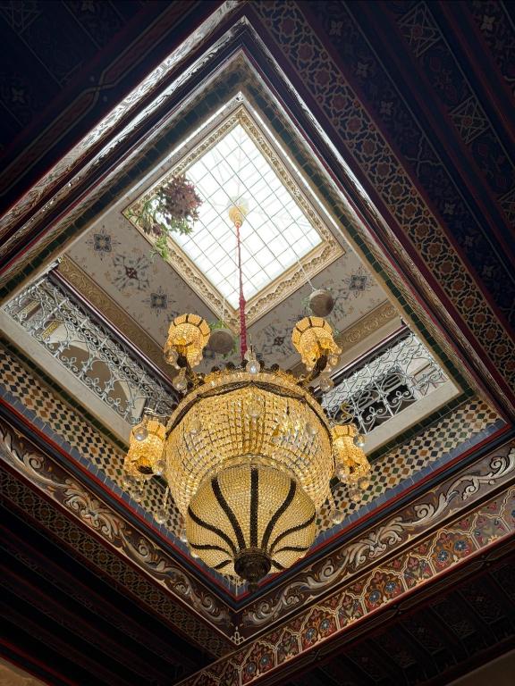 a chandelier hanging from a ceiling in a building at Sherezade Riad in Tétouan