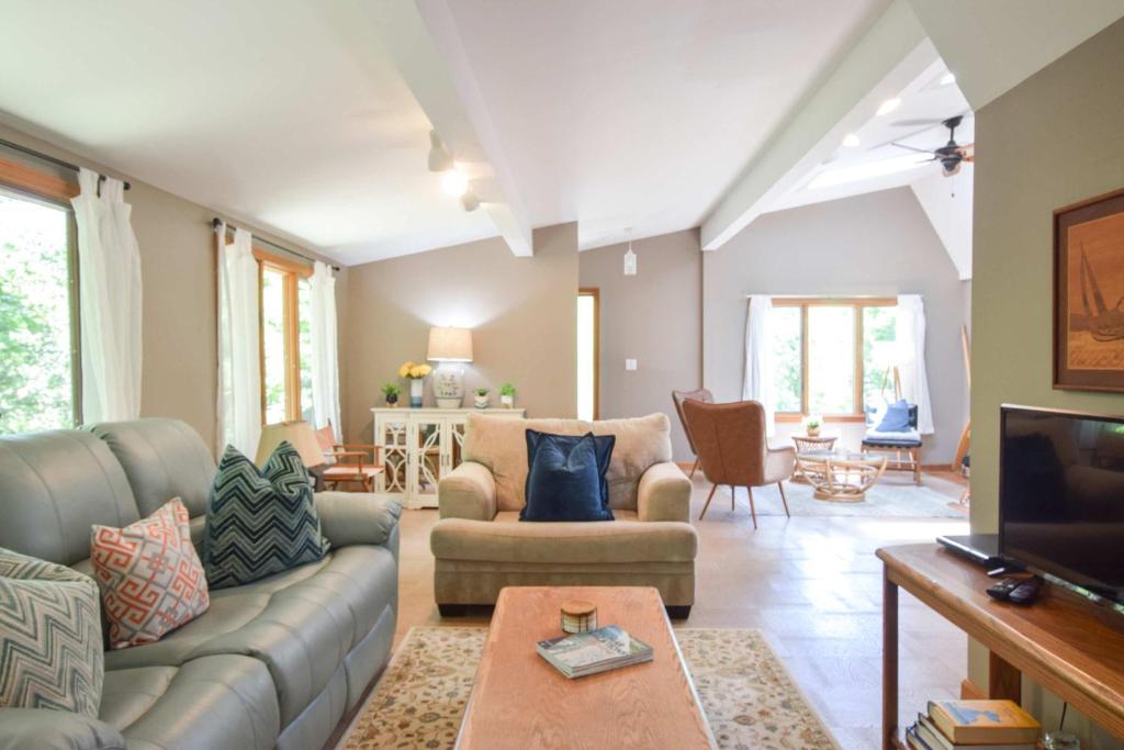 a living room with a couch and a tv at Central AC 3 Min Walk to Pond in Barnstable