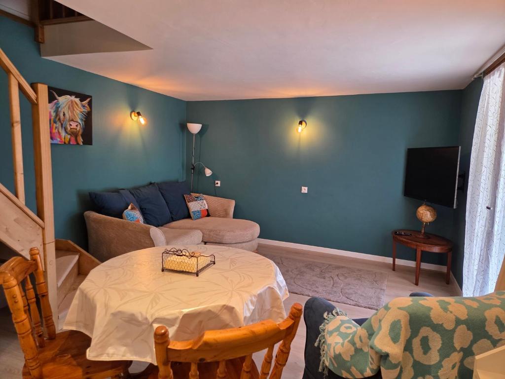 a living room with a table and a couch at Lazy Days Gite in Rancon