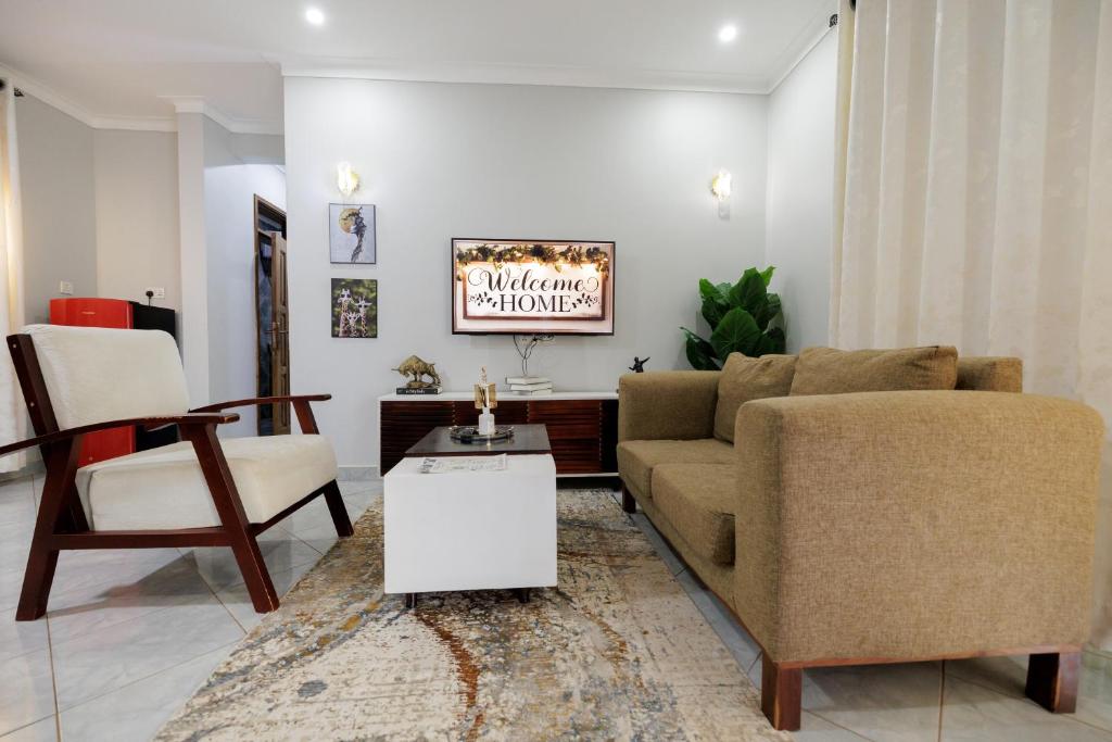a living room with a couch and a table at Luxury & modern 1 Bedroom apartments in Munyonyo-Kampala in Kampala
