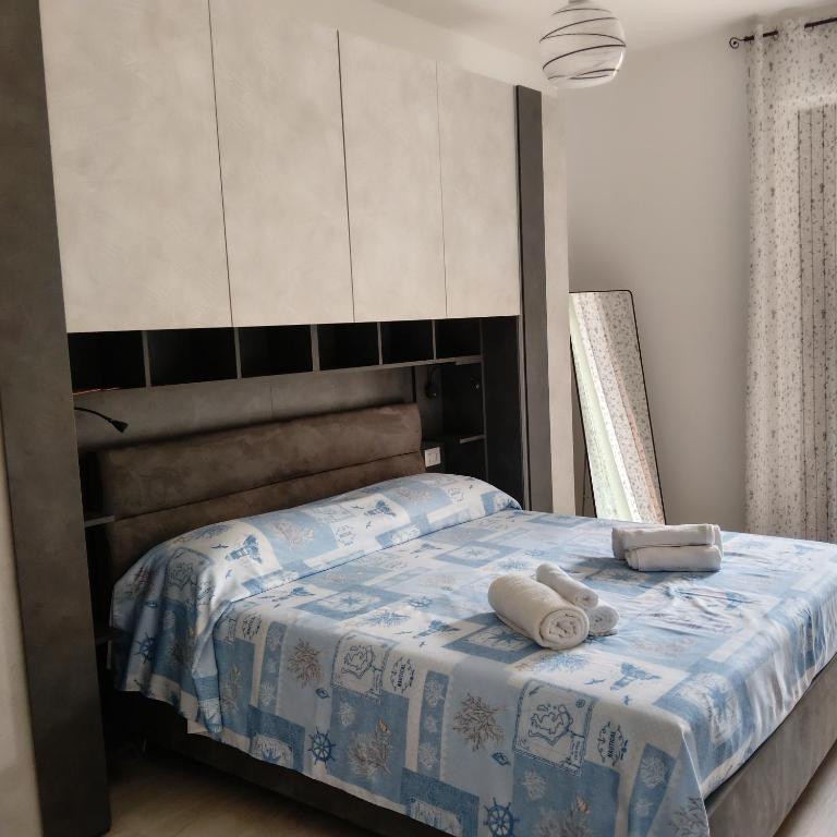 a bedroom with a bed with two towels on it at Brezza marina in Alghero