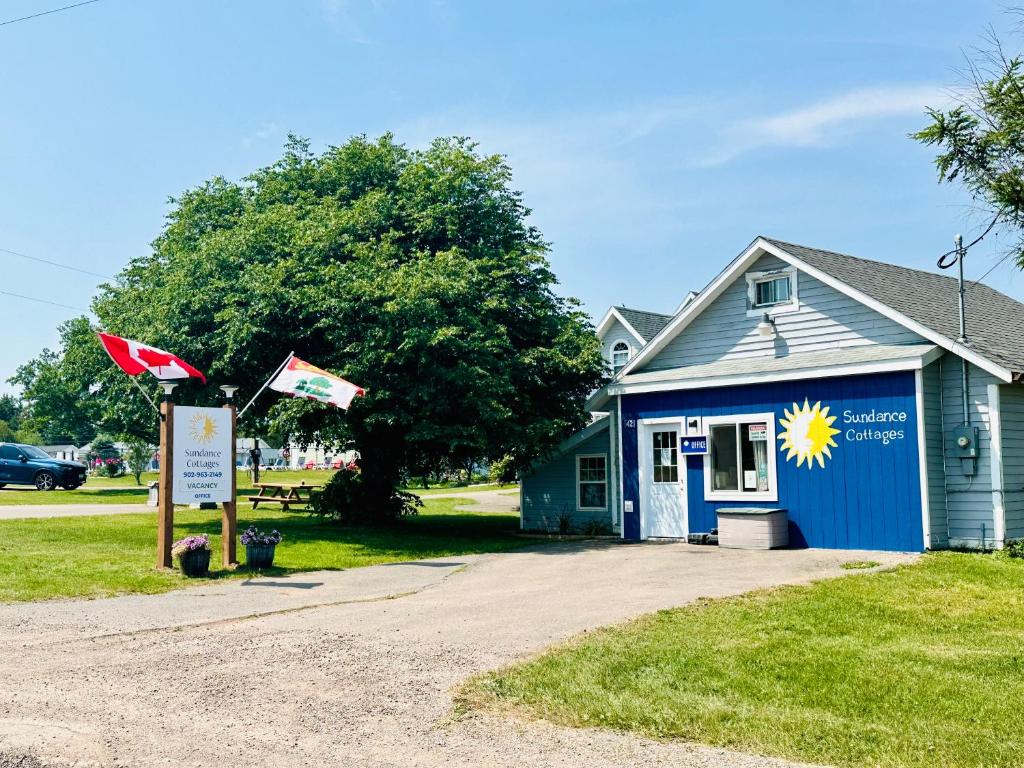 a blue building with a flag in front of it at Sundance Cottages in Cavendish