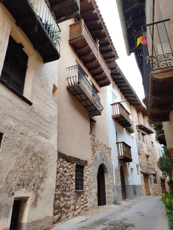 an alley with balconies on the side of a building at Casa Les Donfelises in Peñarroya de Tastavins